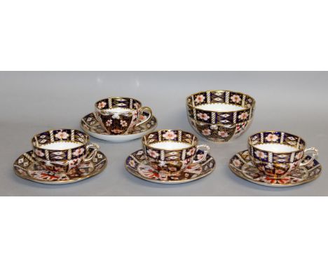 THREE ROYAL CROWN DERBY IMARI CUPS AND SAUCERS with unusual handle and a matching bowl, date code for 1912 and another cup an