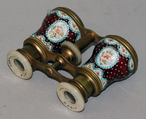 A 19TH CENTURY SET OF OPERA GLASSES by CHEVALIER, PARIS, with pink enamel body painted with flowers with mother-of-pearl eye 