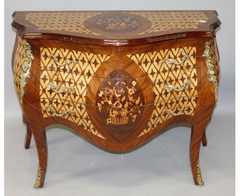 A LOUIS XVI STYLE ROSEWOOD, ORMOLU AND MARQUETRY COMMODE, the top with a basket of flowers and flower head detail, over three