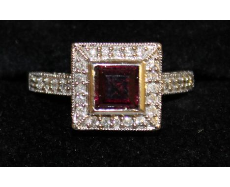 A SQUARE CLUSTER RING, set with garnets and diamonds in 14ct white gold.