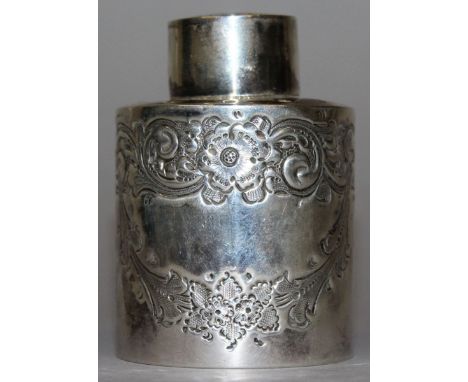 A VICTORIAN CIRCULAR TEA CADDY AND COVER with repousse decoration. Birmingham 1897.