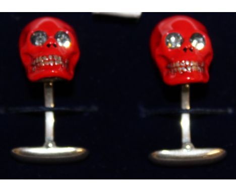 A PAIR RED ENAMEL AND STERLING SILVER CUFFLINKS, in the form of skulls.