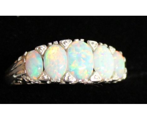 A FIVE STONE OPAL RING set in silver.