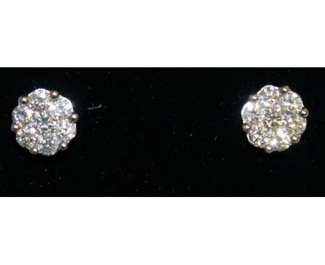 A SUPERB PAIR OF 1CT DIAMOND FLOWER HEAD CLUSTER EARRINGS, set in hallmarked 18ct white gold.