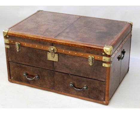 A LARGE LEATHER TRUNK with brass corners, hinges and lock, rising top with long drawer below. 3ft long, 2ft wide, 1ft 7ins hi