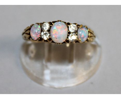 AN OPAL AND DIAMOND HALF HOOP RING, set in 18ct yellow gold.