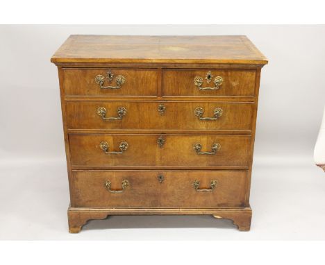 AN 18TH CENTURY WALNUT CHEST OF DRAWERS, with crossbanded quarter veneered top, two short and three long drawers on bracket f