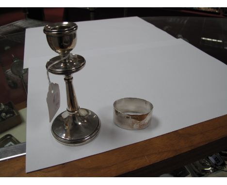 A Hallmarked Silver Candlestick, Birmingham 1921; together with a hallmarked silver napkin ring, Sheffield 1944 (monogrammed)