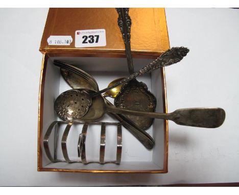 A Hallmarked Silver Five Bar Toast Rack, a hallmarked silver fork and spoon, decorative sifter spoon stamped "Sterling", etc.
