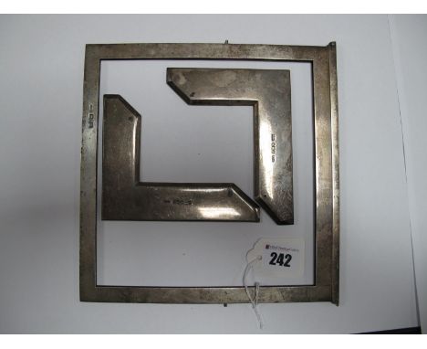 A Pair of Hallmarked Silver Corner Mounts; together with a hallmarked silver frame.