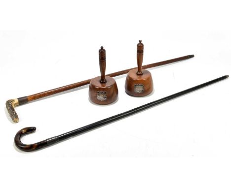 An ebony walking stick with simulated tortoiseshell handle, a malacca cane with antler handle and a pair of mallets with appl