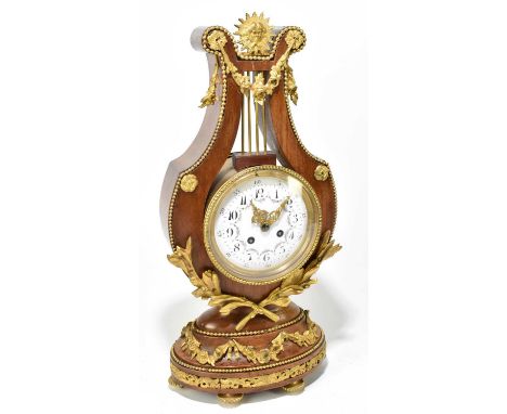 A French ormolu mounted kingwood mantel clock in the form of a lyre, the enamel dial set with both Arabic and Roman numerals 