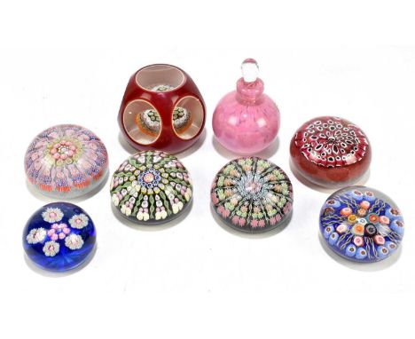 MURANO; a contemporary faceted glass paperweight, with internal millefiori, diameter 8cm, together with six further paperweig