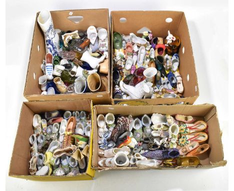 A large collection of assorted model shoes to include Continental porcelain examples, floral encrusted examples, glass exampl