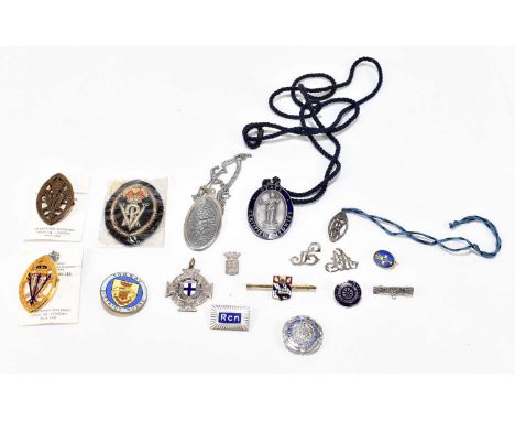 A small assortment of nursing medal and related badges, etc, to include a Torbay District Nurse enamel badge, a State Certifi