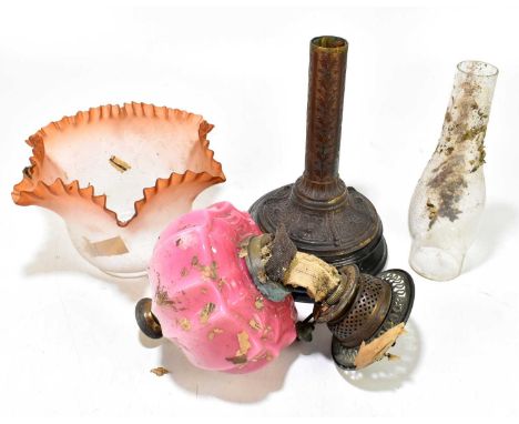 A Victorian oil lamp with cranberry and milk glass reservoir and frosted coloured shade (in need of restoration).Lamp in need