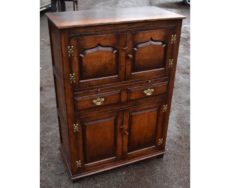 TITCHMARSH &amp; GOODWIN; a reproduction oak cocktail cabinet with pair of panel doors above slide, two drawers and pair of d