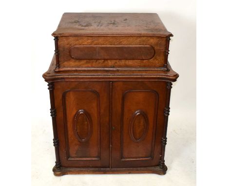 BRADBURY &amp; CO; a Victorian cast iron sewing machine mounted in walnut cabinet with two panel doors to base enclosing fitt