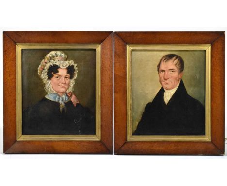 A pair of 19th century oils on canvas, a portrait of a gentleman wearing a black overcoat and a lady wearing a bonnet hat, ap