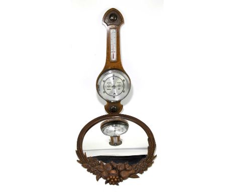 A reproduction carved mirror of circular form decorated with fruit, diameter 49cm, together with an oak wheel barometer (2).