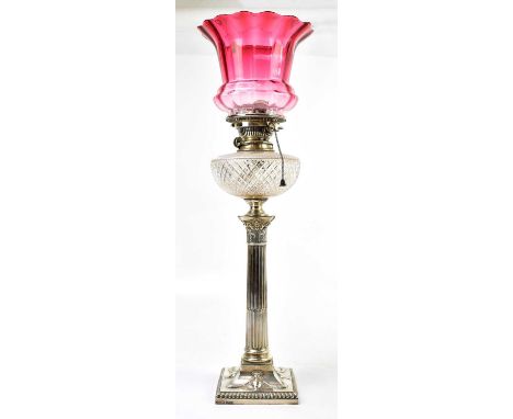 HAWKSWORTH EYRE &amp; CO LTD; an Edward VII hallmarked silver mounted oil lamp with cranberry glass shade, above the cut glas