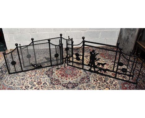 Two pairs of decorative hunting themed wrought iron fire guards, width 111cm and 134cm, also a pair of tongs.