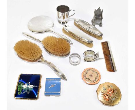 An assortment of silver and silver plated items to include a four piece dressing table set, a christening can, a napkin ring 