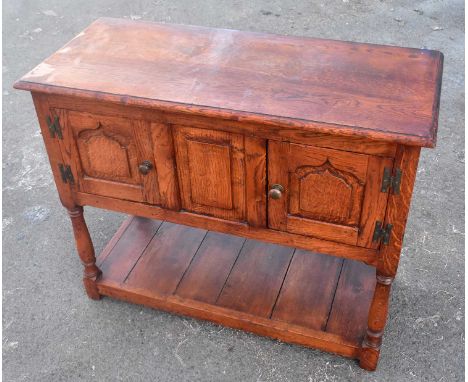 A reproduction oak credence cupboard with pair of panel doors above undertier, width 93cm.