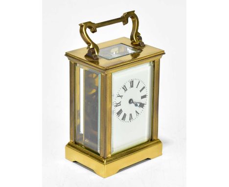 A brass cased carriage clock with rectangular white enamel dial set with Roman numerals, height 13cm, sold with receipt from 