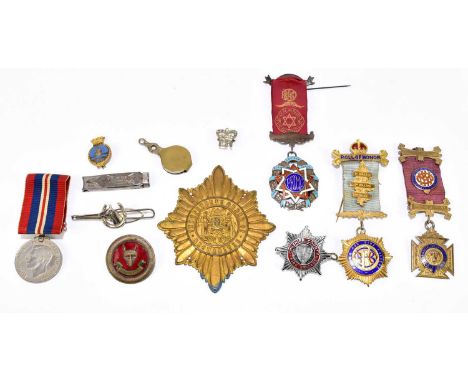 A WWII Defence Medal together with a collection of further medals and badges to include a hallmarked silver Masonic example f