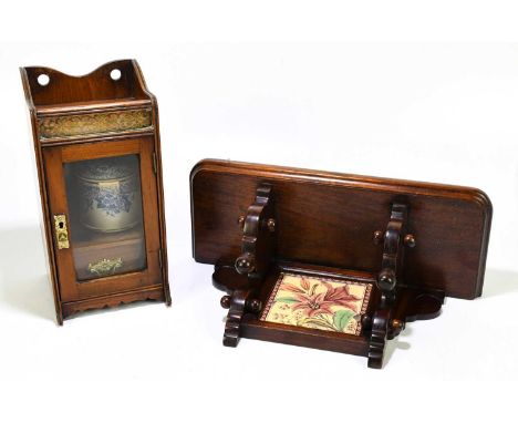 A late Victorian smoker's cabinet with brass gallery front above the glazed door enclosing a ceramic tobacco jar with cover, 