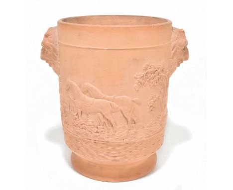 A 19th century terracotta ice bucket in the manner of Davenport with grotesque mask head and embossed hunting decoration, unm