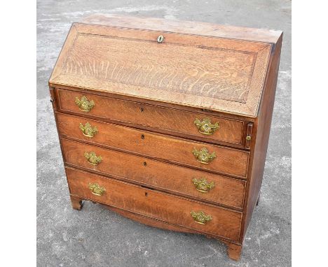 A Georgian oak bureau, the crossbanded fall front enclosing a fitted interior above four long drawers on bracket feet, width 