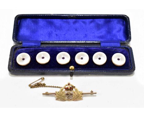 A 9ct gold and enamel naval sweetheart brooch, set with a single garnet, length 5cm, gross weight 4.8g, with a set of six 9ct