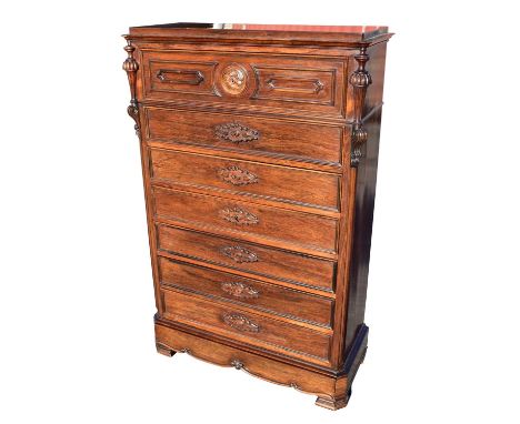 A 19th century French rosewood secretaire semanier, the secretaire drawer with fall down front enclosing an arrangement of fi