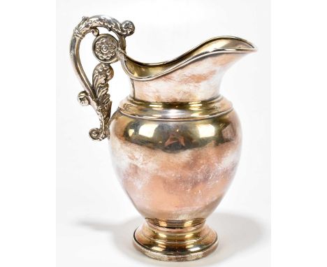 A 19th century Continental white metal jug, with acanthus leaf scroll handle, two marks to the underside of the base, gross w