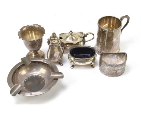 A hallmarked silver three piece cruet, Birmingham 1953, also a London hallmarked christening mug, an egg cup, napkin ring, as