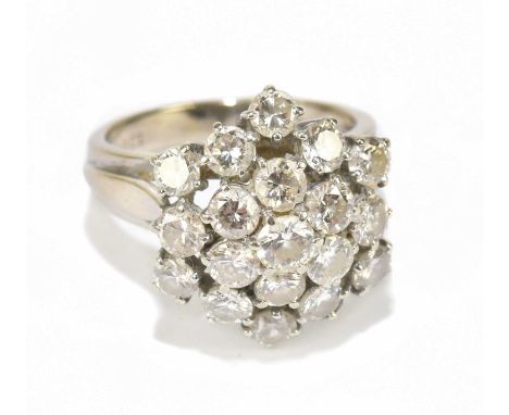 A white metal diamond floral cluster ring stamped 18ct, set with nineteen round brilliant cut diamonds, approx size N, approx