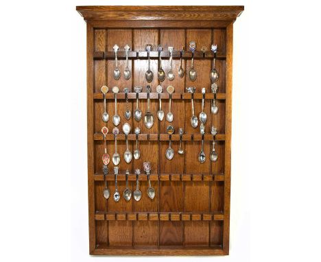 An oak spoon rack containing a collection hallmarked silver and silver plated spoons, to include five hallmarked silver and o