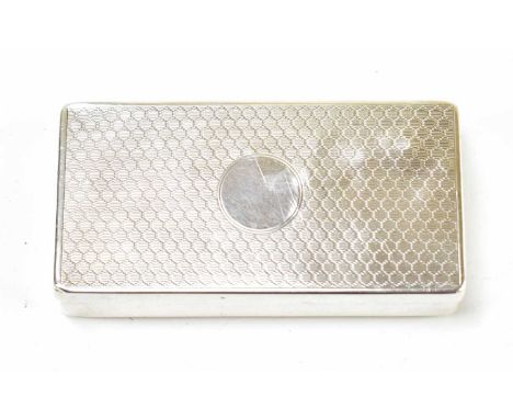 A George V hallmarked silver snuff box of rectangular form, the hinged cover with engine turned decoration surrounding a circ