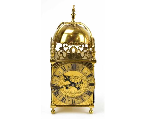 A French brass lantern clock with urn finial above the applied chapter ring bearing Roman numerals, height 37cm.Clock does no