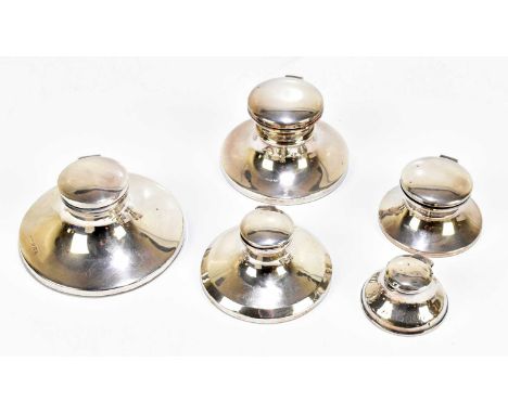 A collection of five hallmarked silver Capstan inkwells, the largest Birmingham 1929, diameter 11cm (loaded) (5).The four lar
