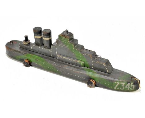 A vintage painted wooden model of a battleship numbered 734F, with remains of original label, length 42cm.