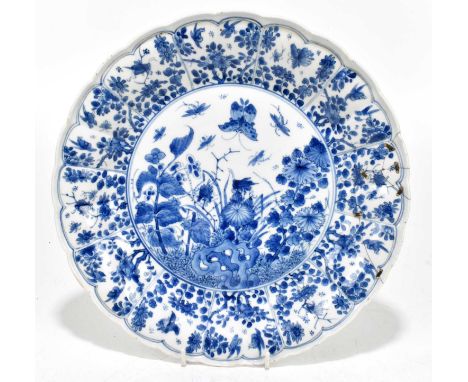 An 18th century Chinese blue and white Kanxi porcelain bowl with scalloped edge, decorated with insects and floral sprays, be