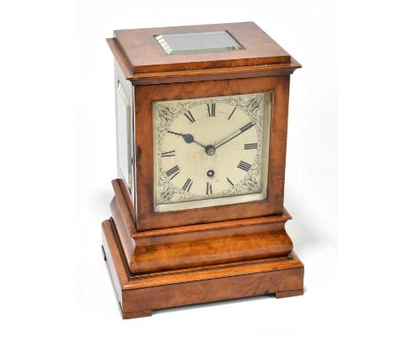 A 19th century walnut cased four glass clock, the silvered dial set with Roman numerals and scrolling detail, with fusee move