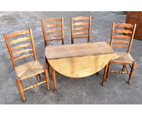 A Georgian oak oval drop-leaf gateleg table and a set of four rush seated ladder back chairs (5).
