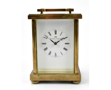 MATTHEW NORMAN; a lacquered brass eight day carriage clock, with Roman numeral dial and movement striking on a gong, numbered