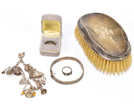 A hallmarked silver backed clothes brush, together with a hallmarked silver snap bangle, a hallmarked silver charm bracelet w