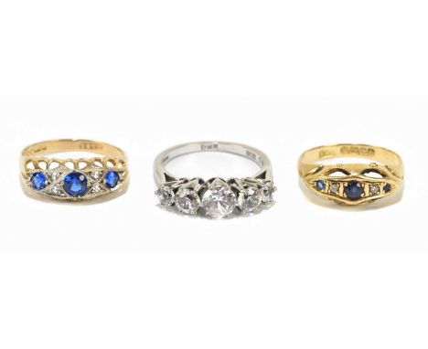 An 18ct yellow gold diamond and sapphire set five stone dress ring, approx size K, an 18ct white gold dress ring set with fiv