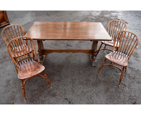 A reproduction oak rectangular dining table, 153 x 84cm, and a set of four comb back chair with crinoline stretchers (5).